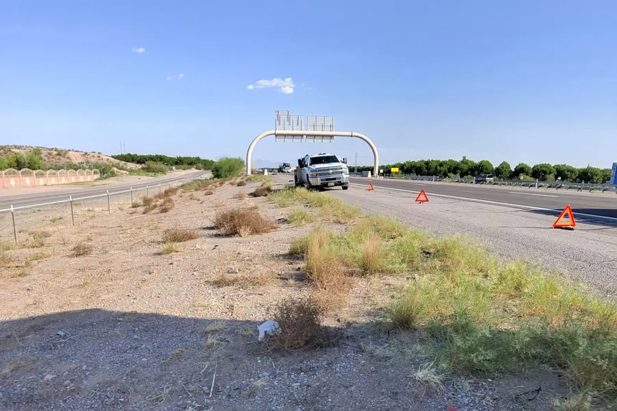 Service truck and warning triangles on the interstate shoulder in the New Mexico desert